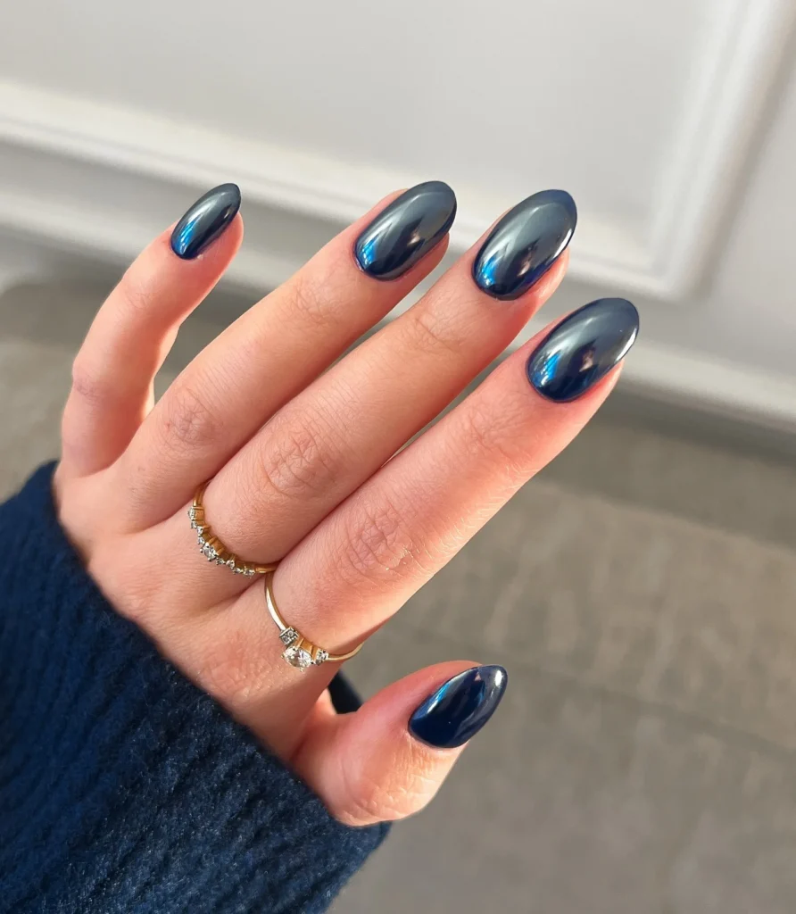 Navy blue chrome nails with a glossy mirror finish