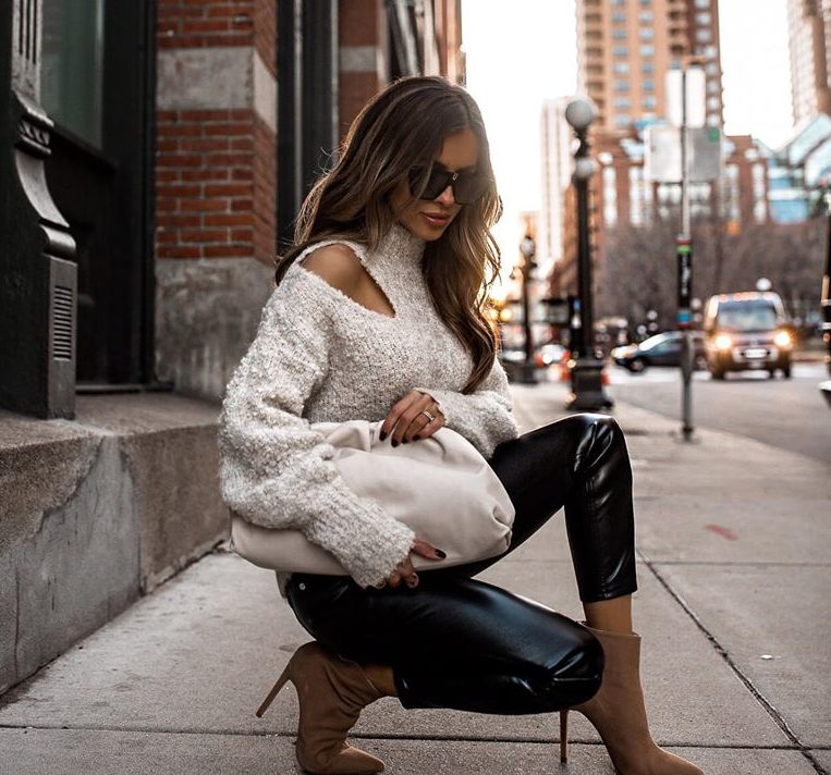Cream textured knit sweater with black leather leggings and tan sock boots