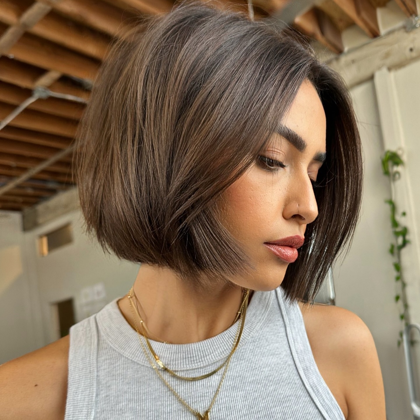 Sleek one-length bob with no bangs on glossy dark hair