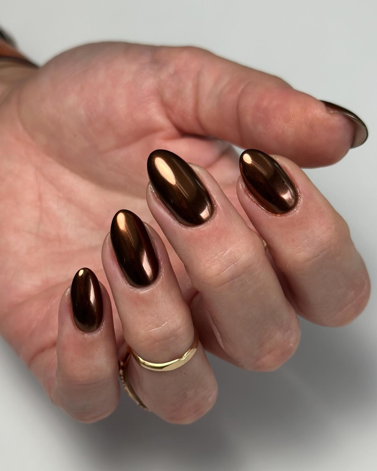 Almond nails in dark bronze metallic chrome
