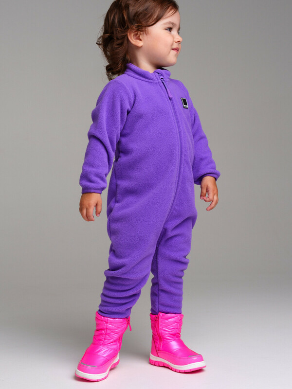 A toddler wearing a warm fleece one-piece outfit with winter boots