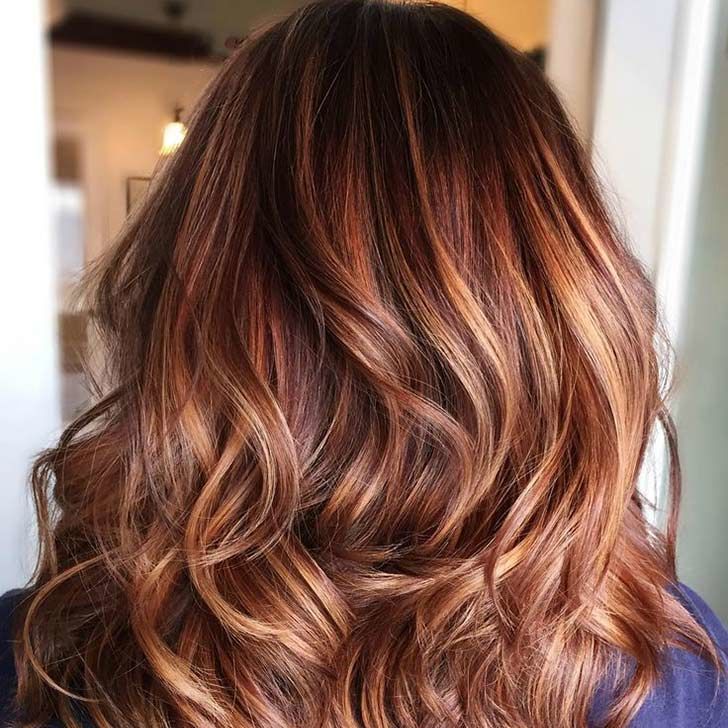 Long center-parted deep mocha hair with an amber money piece highlight