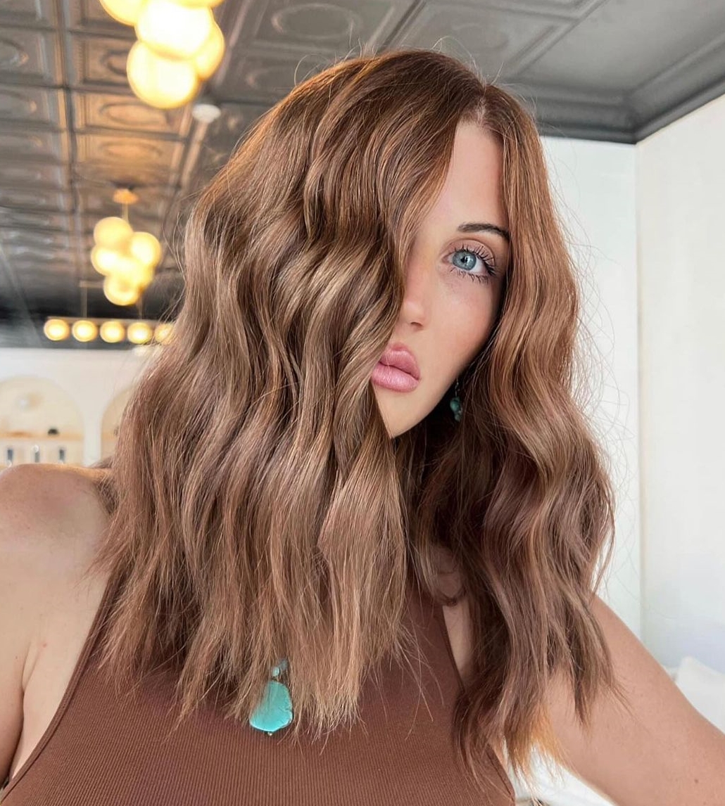 Medium-long layered bronze brown hair with soft waves