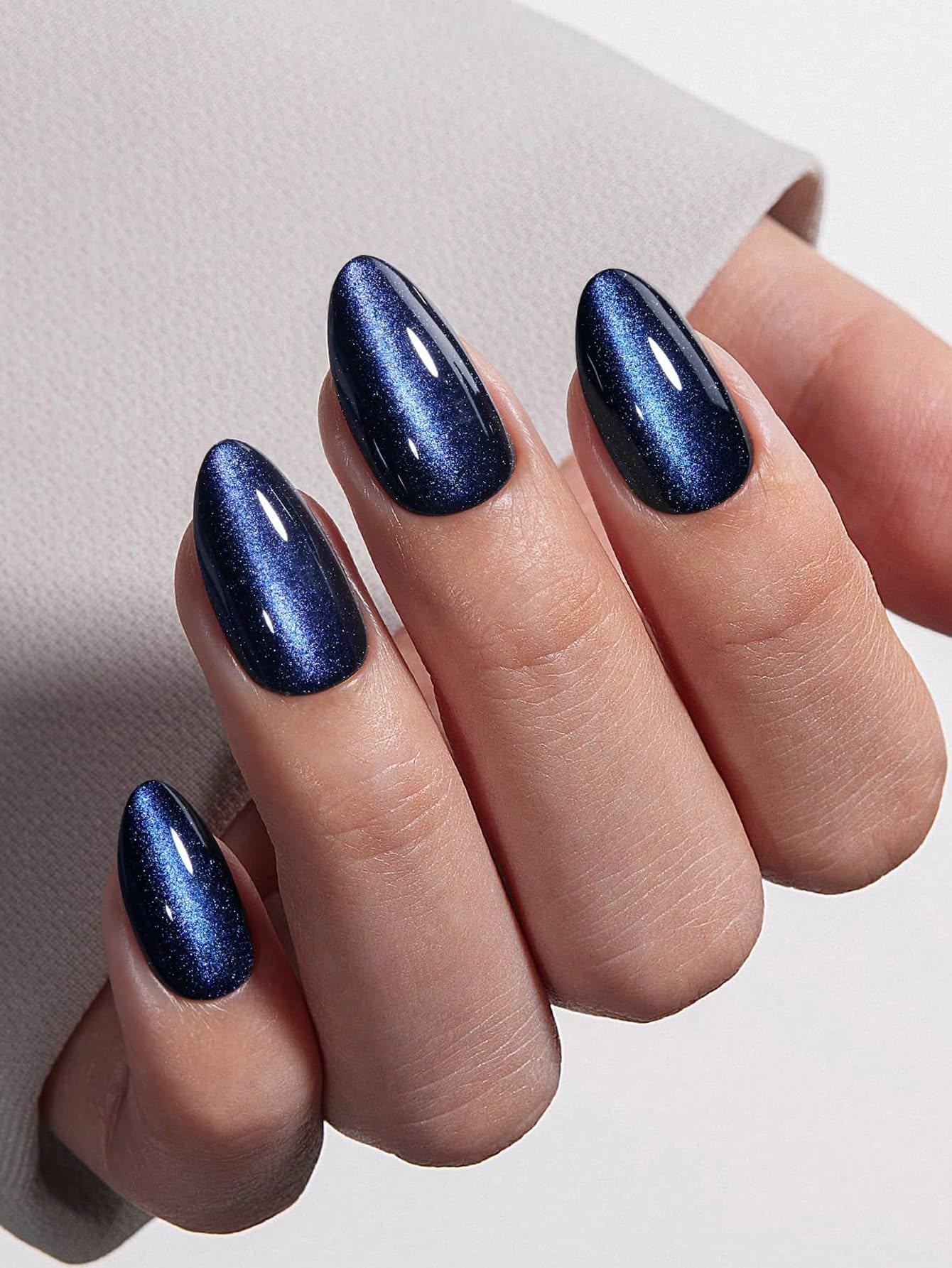 Deep navy blue cat eye nails with magnetic shimmer stripe