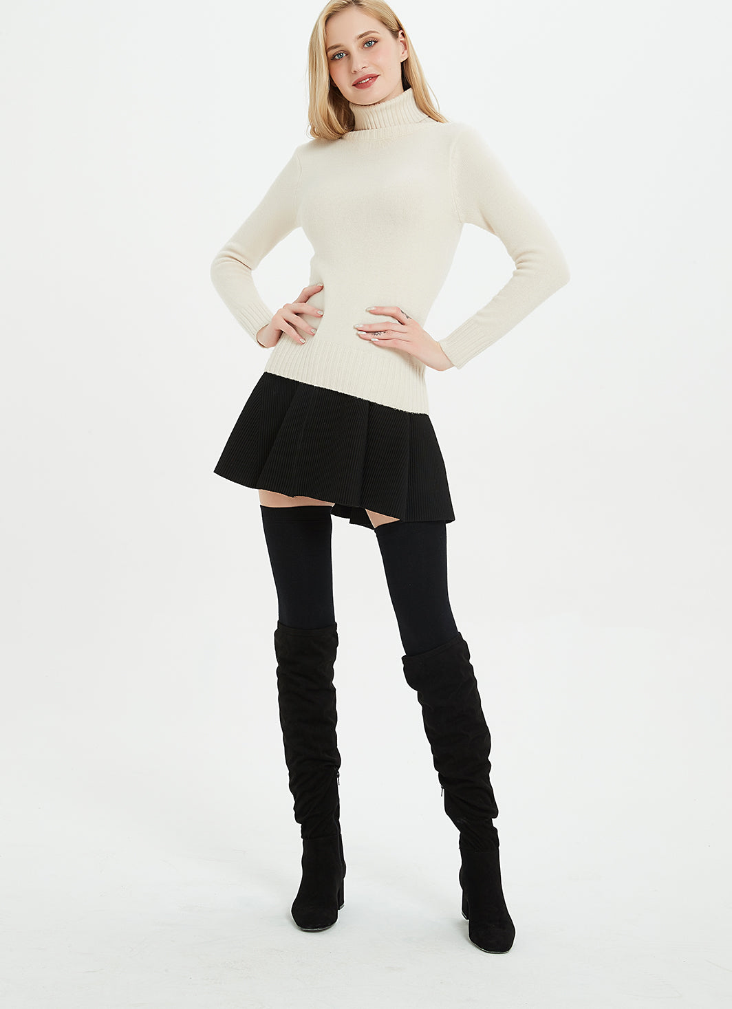 Woman in a white turtleneck sweater, black pleated mini skirt, black thigh-high socks and black suede over-the-knee boots