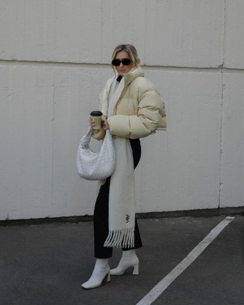 Woman wearing a cropped puffer jacket with a relaxed winter outfit