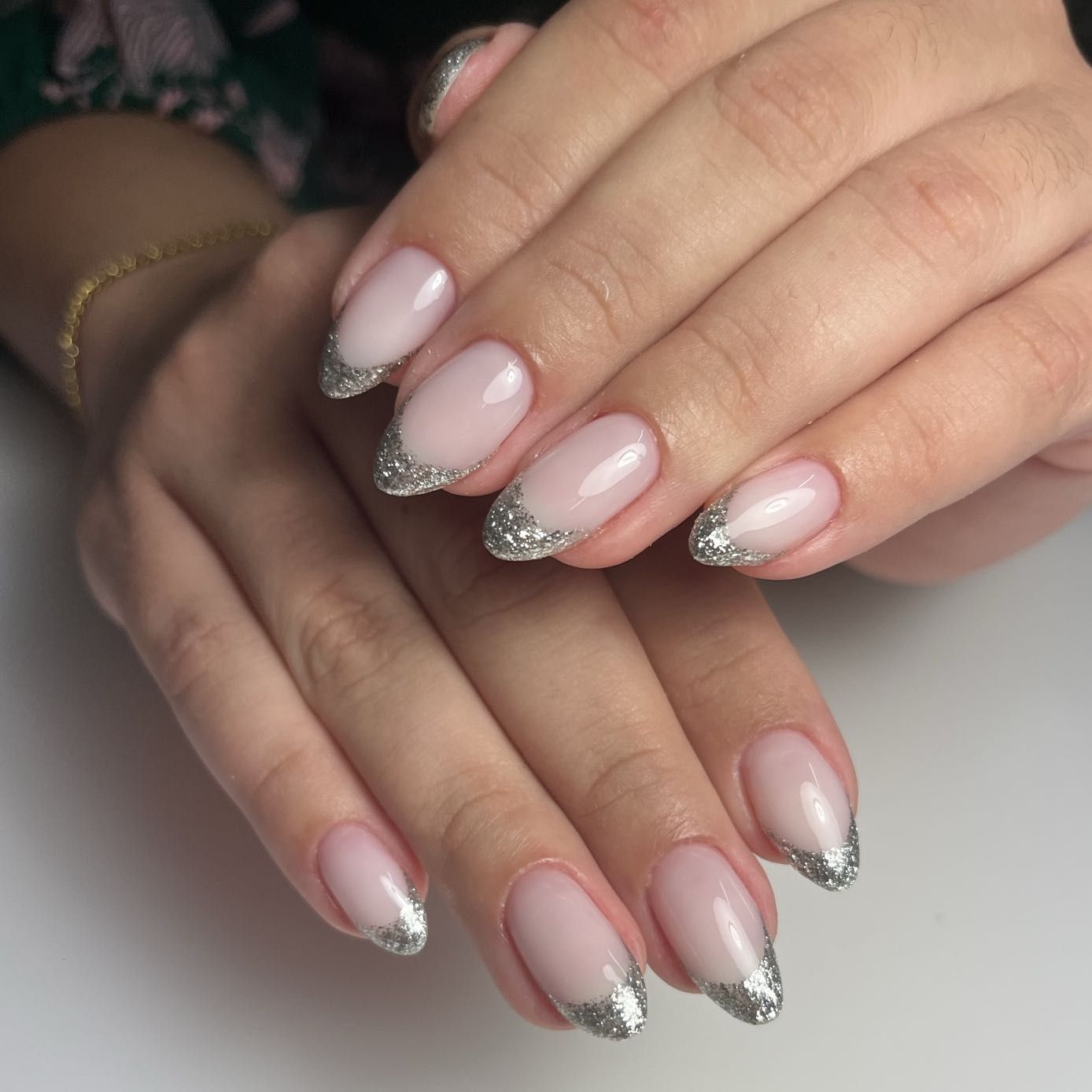 Almond nude nails with silver glitter French tips