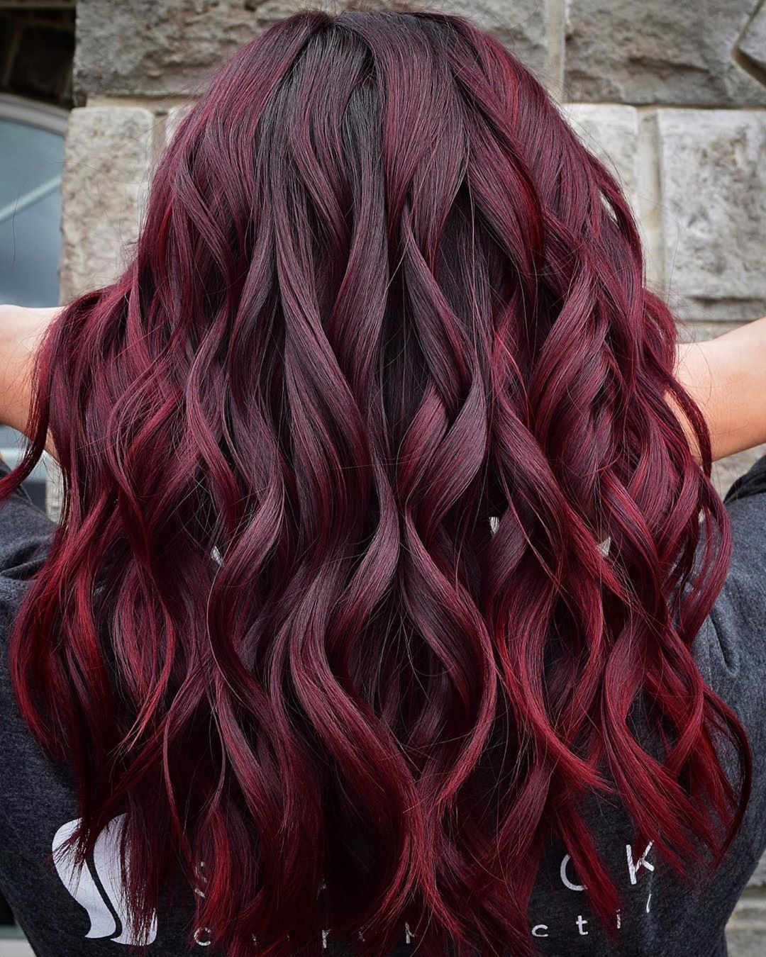 Burgundy ombre on long curly hair with darker roots