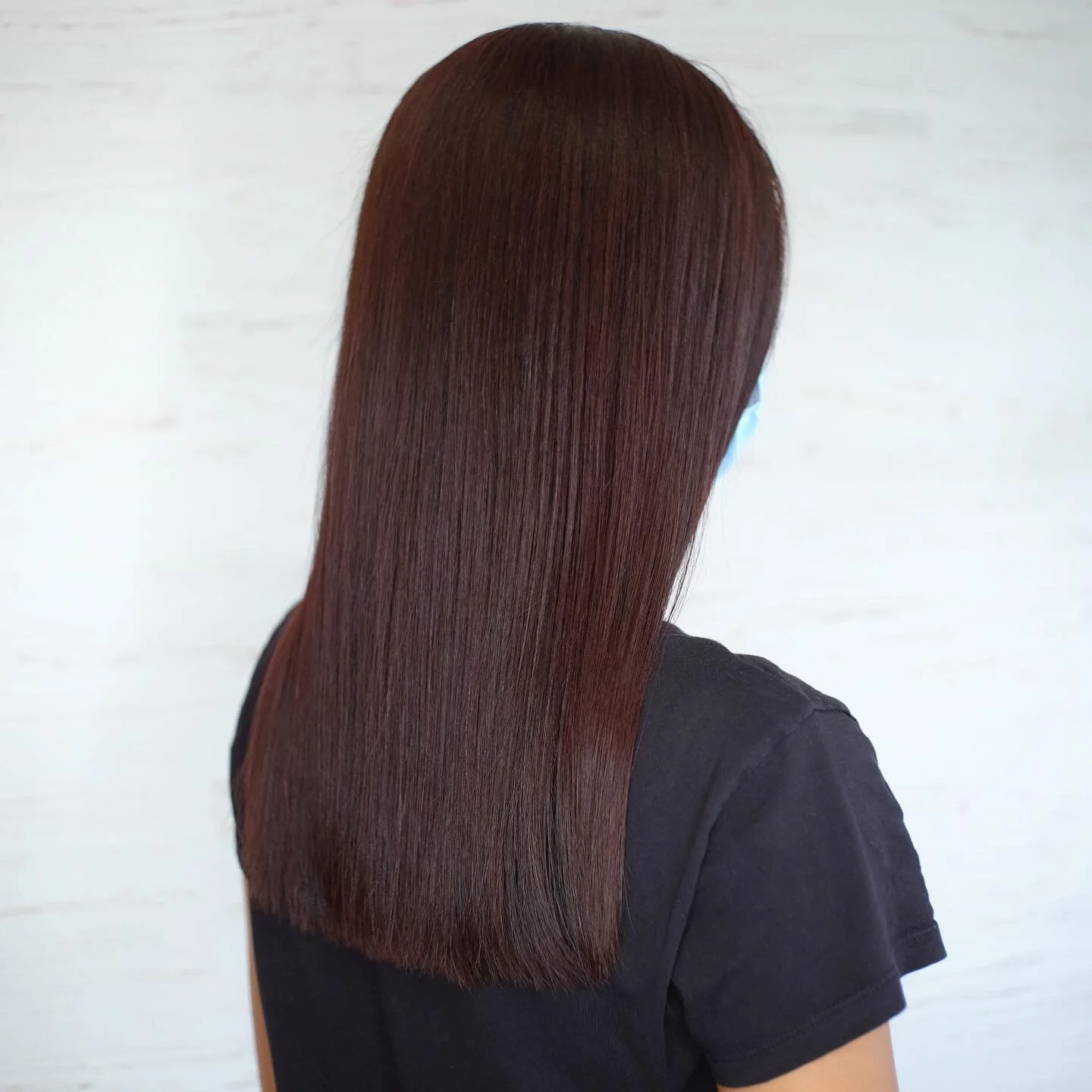 Sleek straight dark mahogany hair worn long