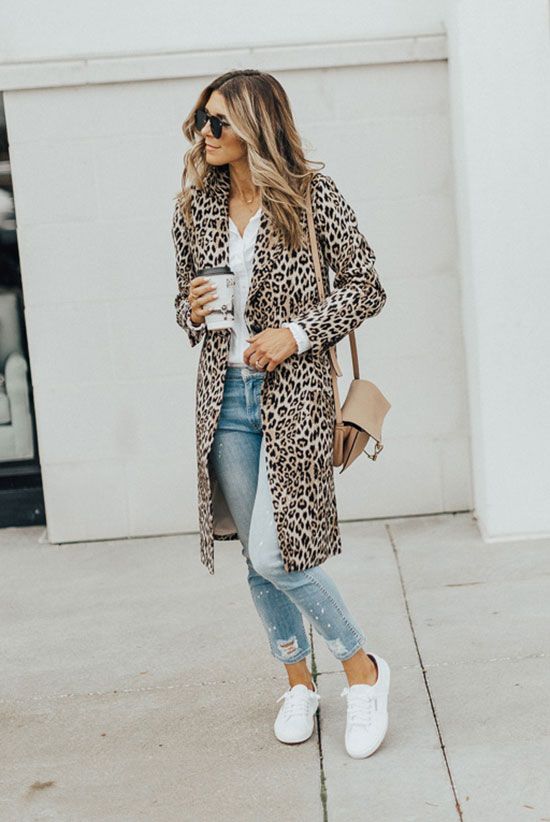 Long leopard print coat with white shirt, light-wash jeans and white sneakers