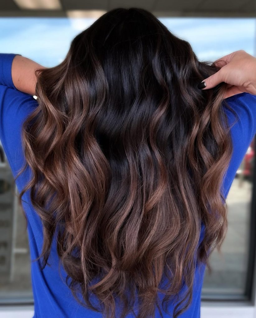 Woman with dark brown hair and chunky caramel copper face-framing highlight pops