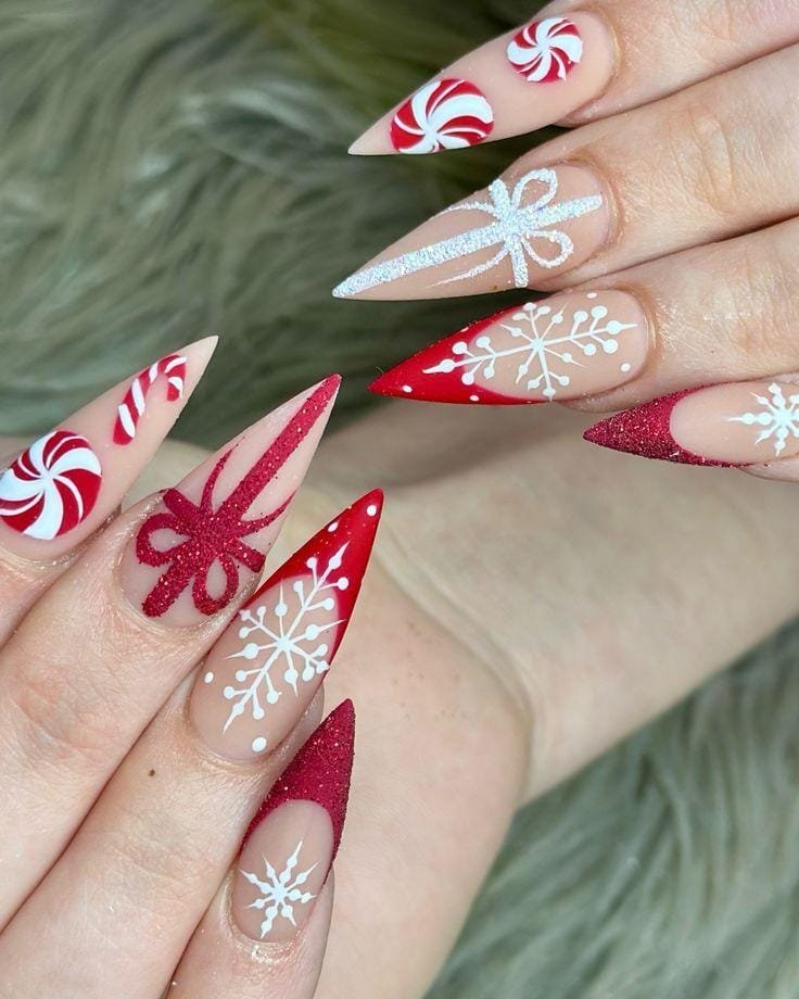 Stiletto nails with candy swirl art, glitter bows and snowflakes in red and white