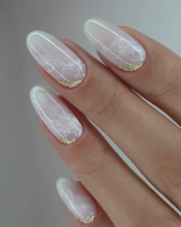 White marble almond nails with gold glitter accents