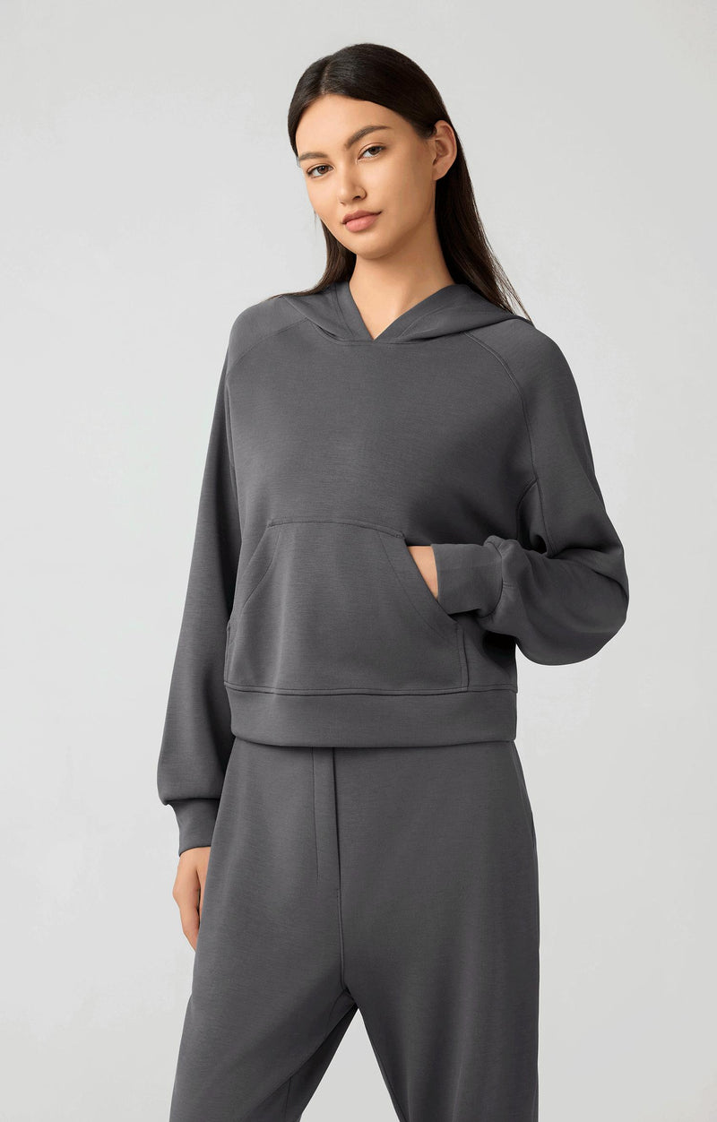 Woman in a dark grey cropped hoodie with matching dark grey sweatpants