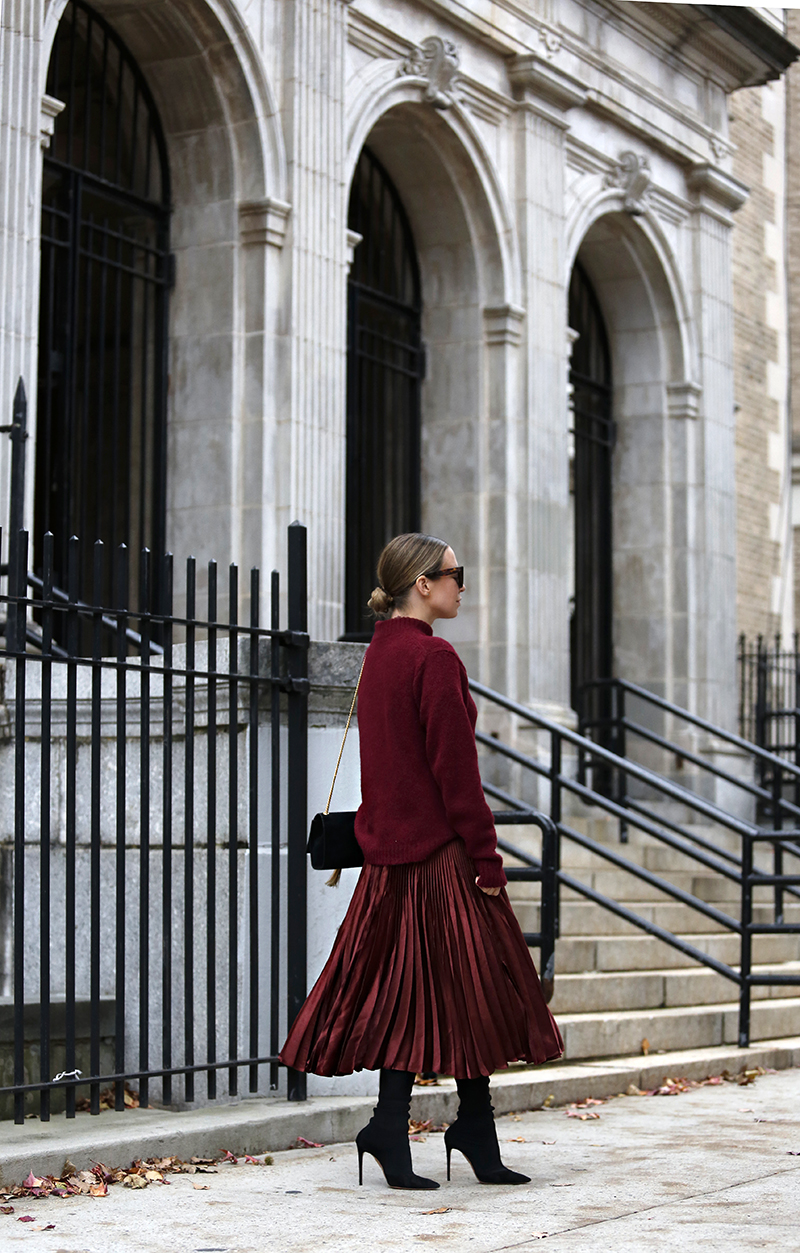 Woman wearing a burgundy pleated skirt