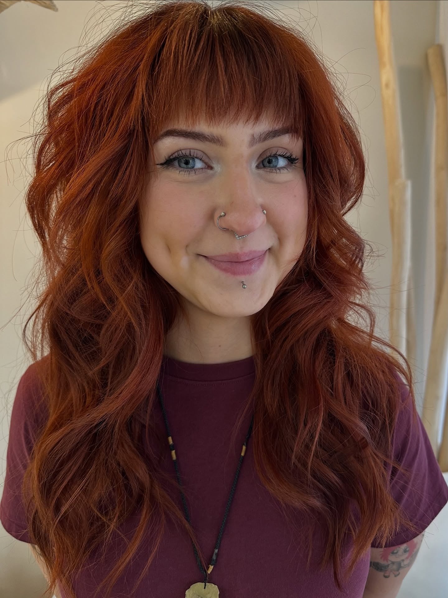 Rust copper hair with wispy bangs and shoulder-length layers