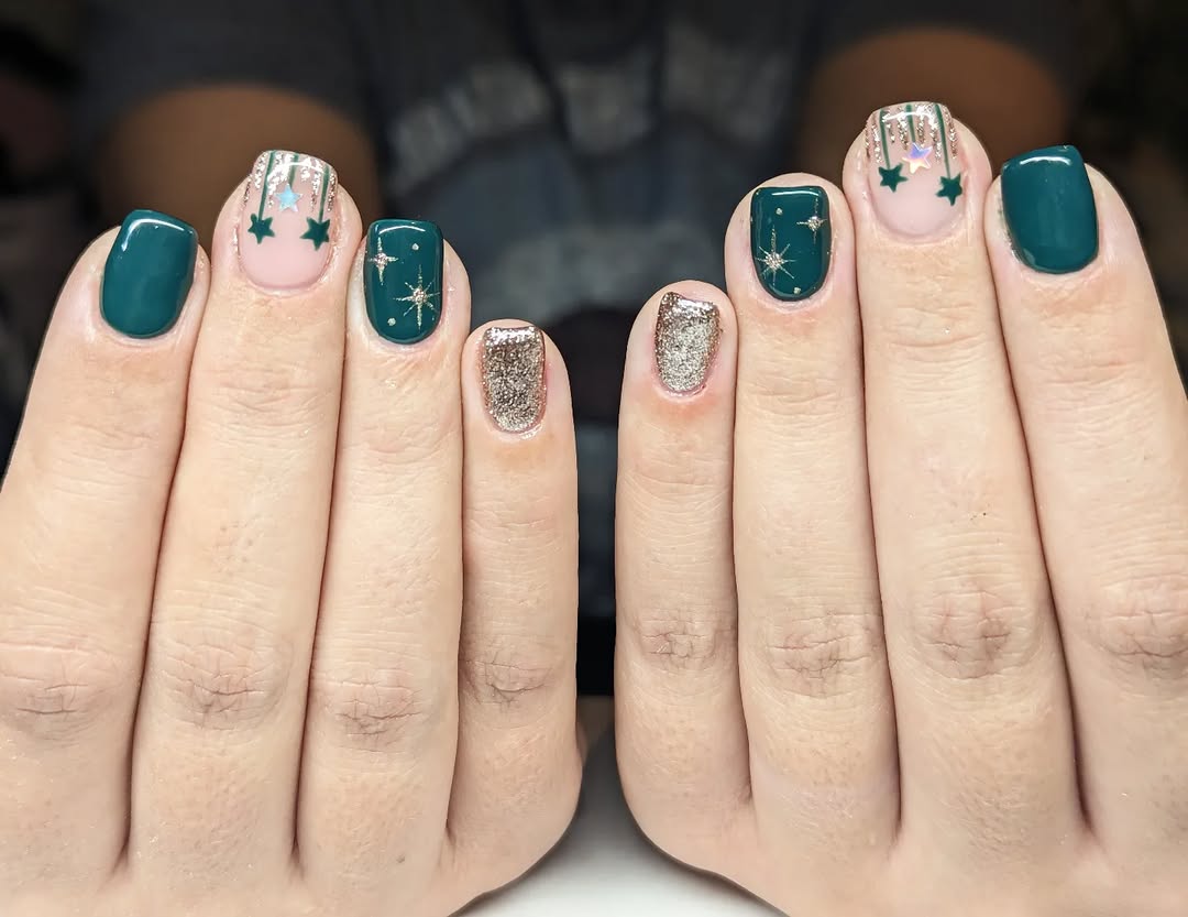 Deep green short square nails with gold starbursts and glitter