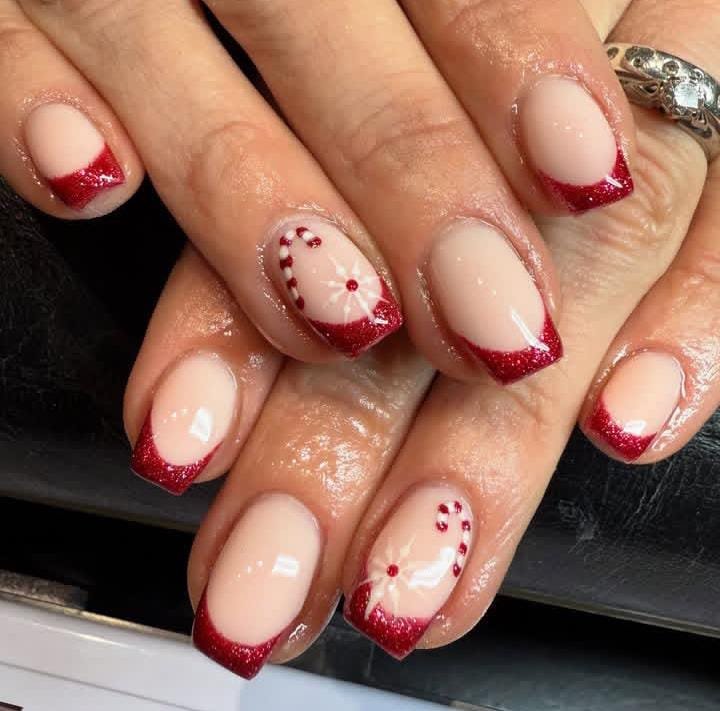 Short nude Christmas nails with red glitter French tips and candy cane art
