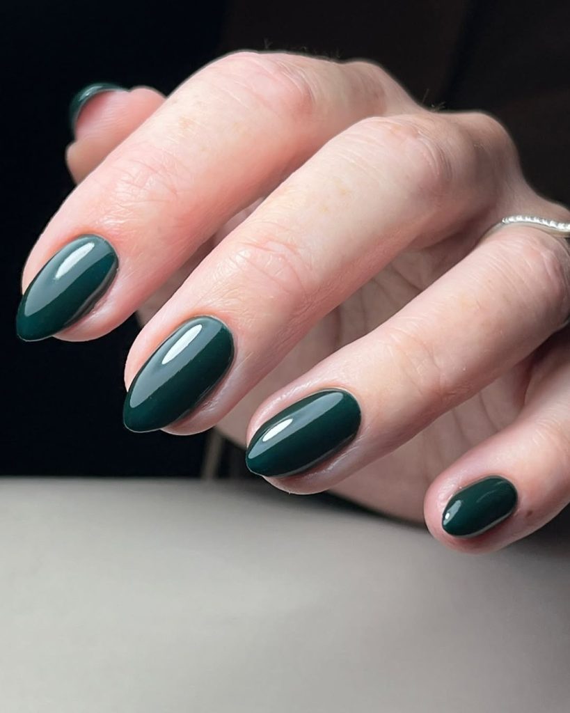 Almond nails in deep forest green glossy polish