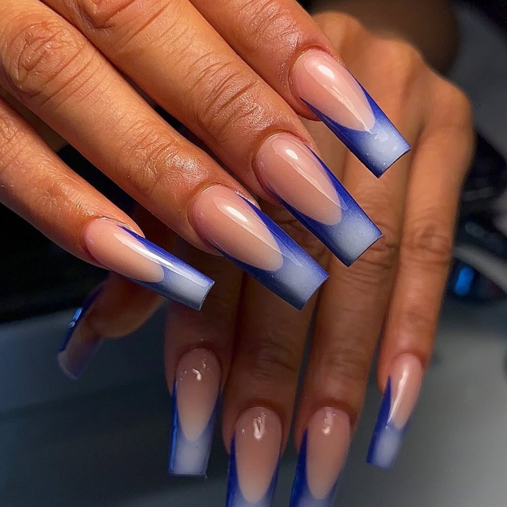 Long coffin nails with navy blue ombré French tips fading into nude