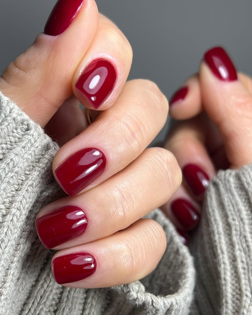 Glossy deep cherry red oval nails