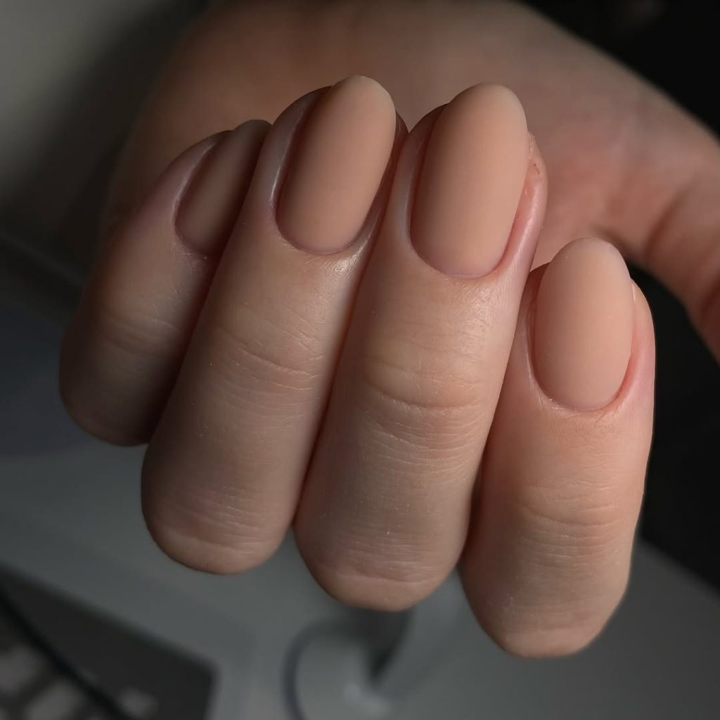 Almond nails in a matte nude beige polish