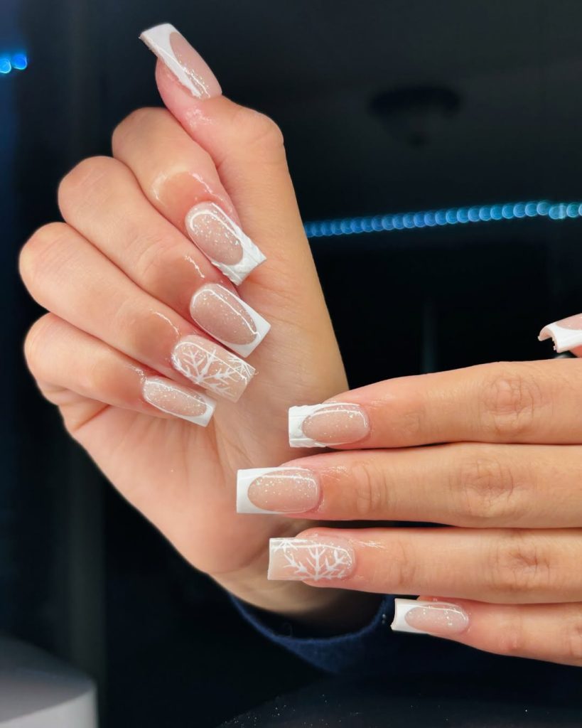 White French tip nails with snowflake art on long square nails