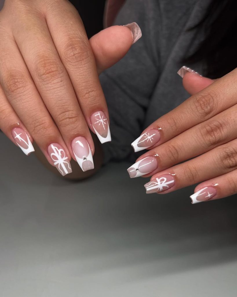 Long square white french nails with hand-painted white bows and starburst sparkles