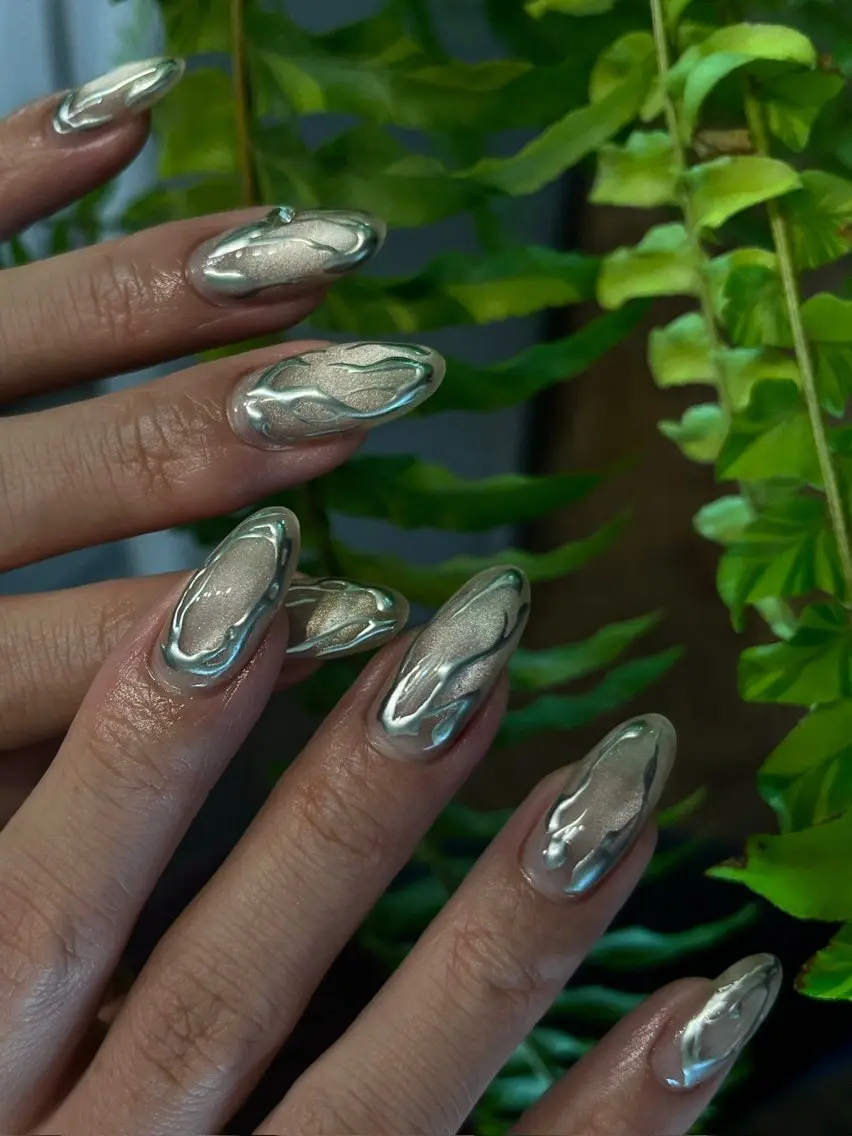 Almond gel nails with liquid silver metallic swirl nail art