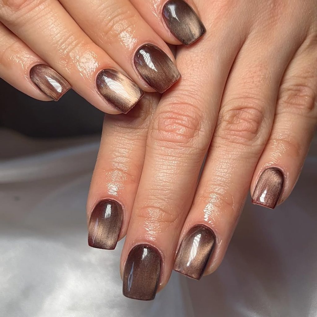 Bronze-brown cat-eye magnetic shimmer polish on squoval nails