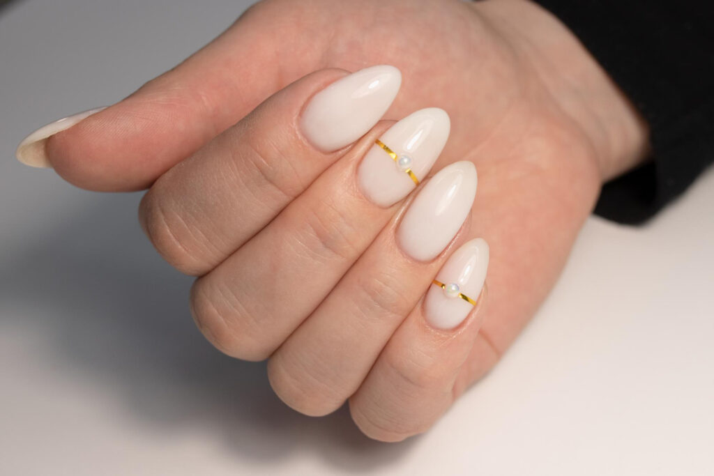 Milky white sheer nails with small pearl accent details
