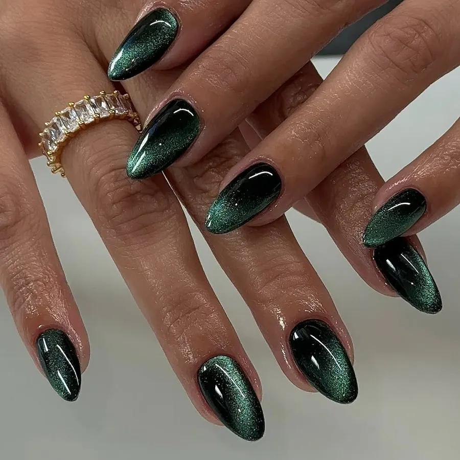 Almond nails in emerald green magnetic cat-eye polish