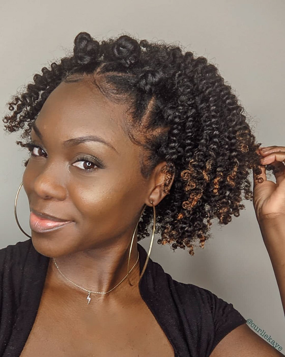 Twist-out hairstyle with bantu knots on top