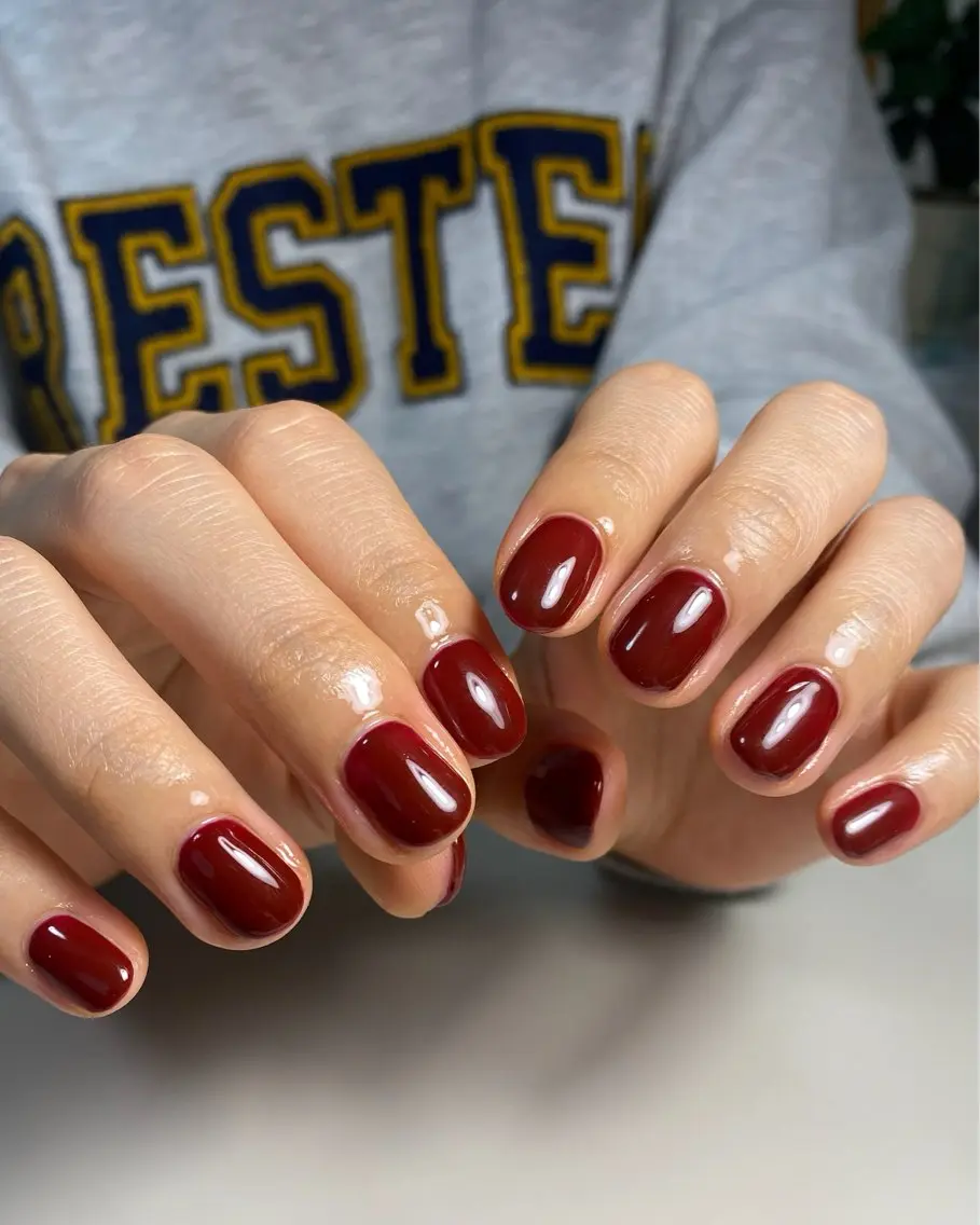 Short round nails in juicy glossy black cherry polish