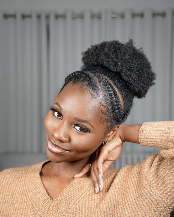 High afro puff with flat twists leading into the puff