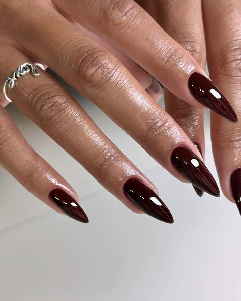Close-up of burgundy acrylic nails