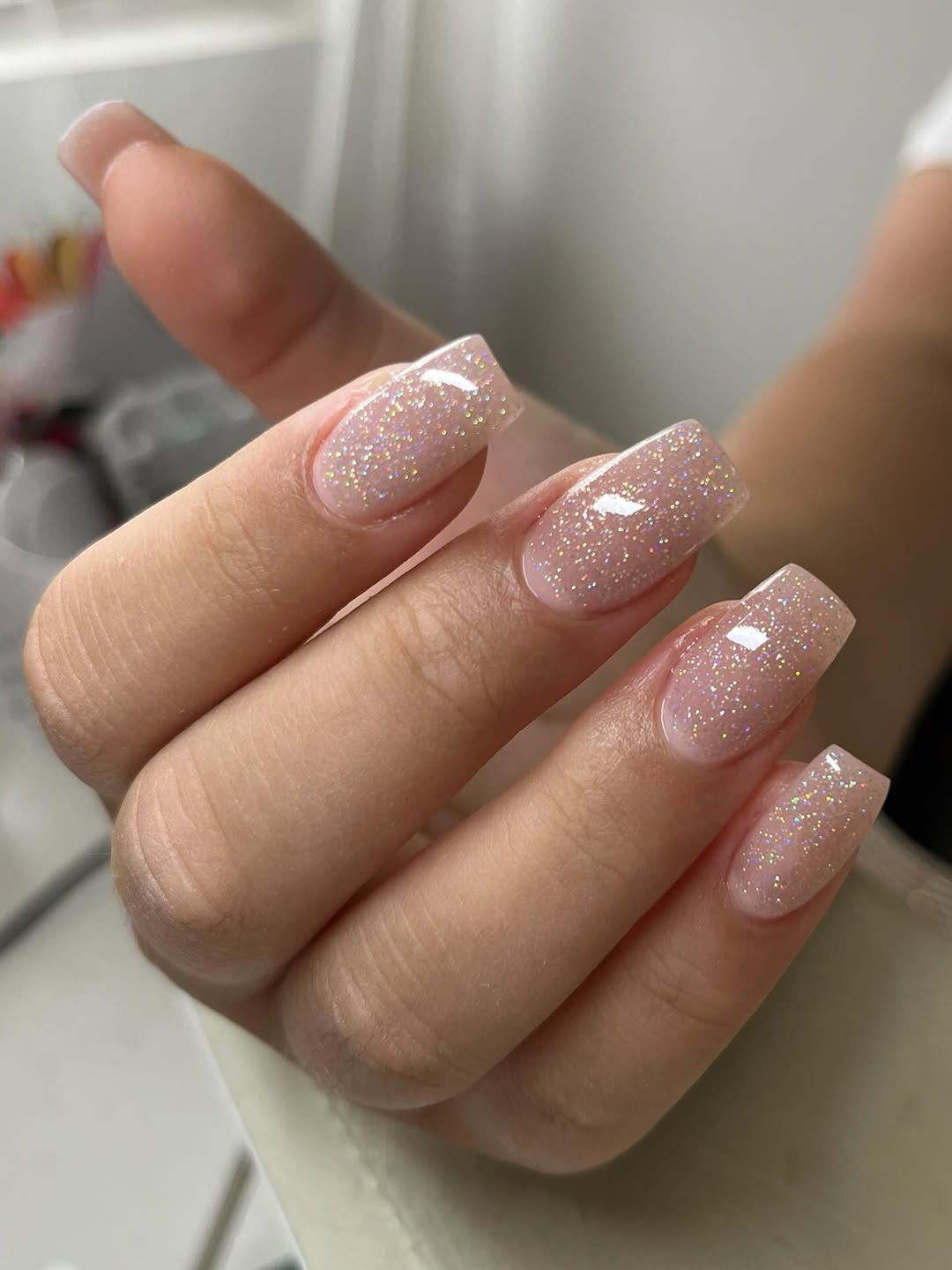 Square sheer nude nails with fine holographic glitter