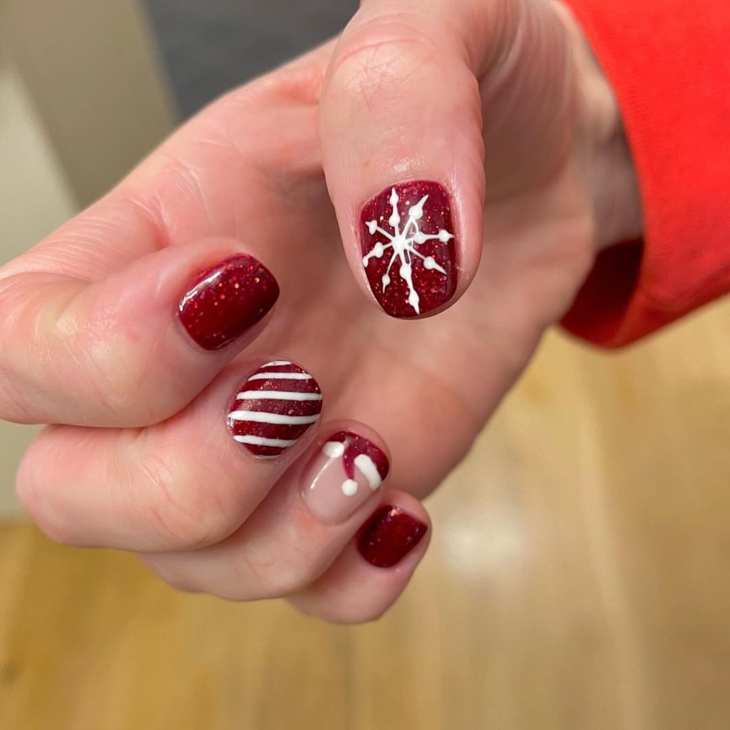 Short deep red Christmas nails with stripes, snowflake and Santa hat art