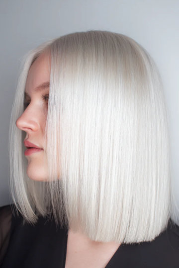 Sleek straight icy platinum blonde lob, side view
