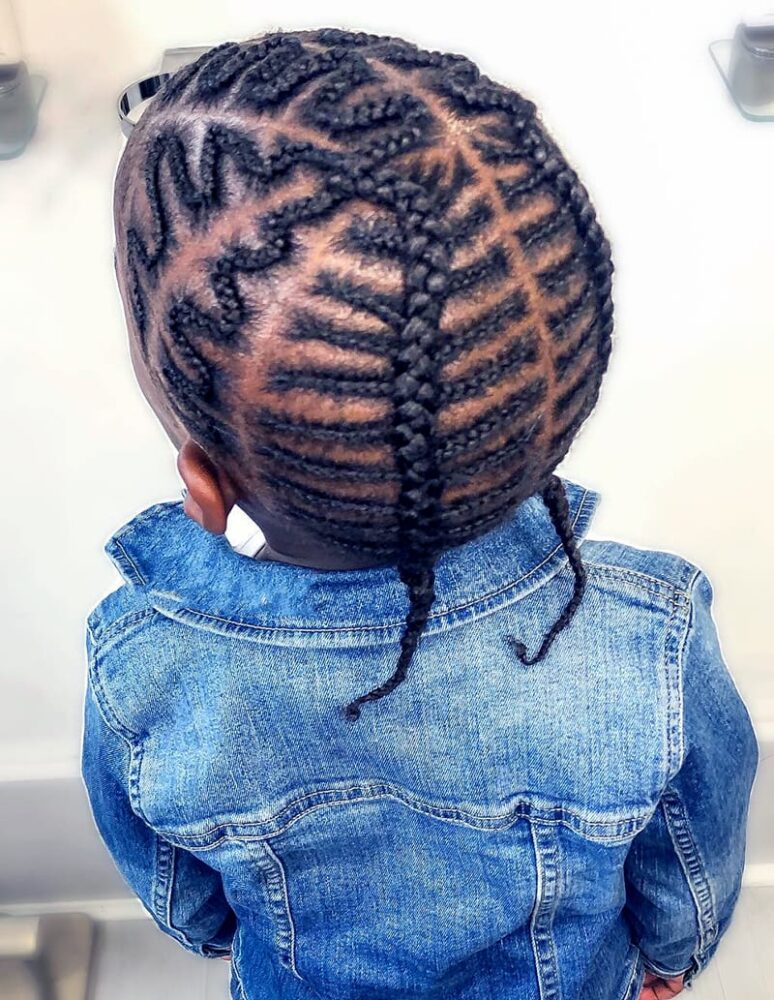 Back view of a child with zigzag-parted cornrows in a denim jacket