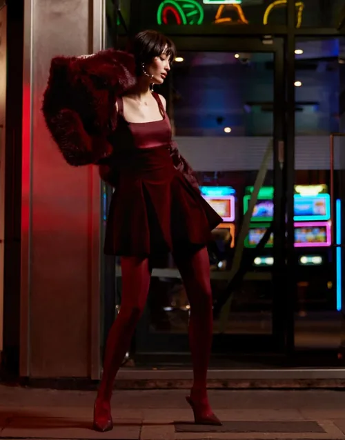 Burgundy mini dress with matching tights and faux-fur coat