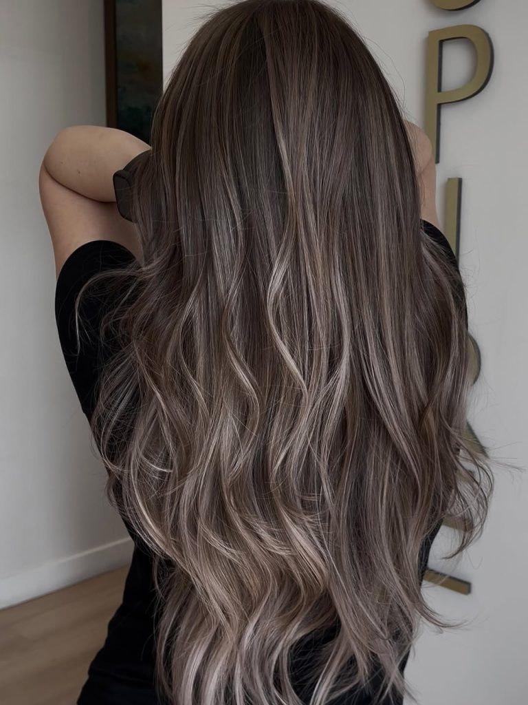 Woman with light brown hair and a whisper of ashy blonde face-framing highlights