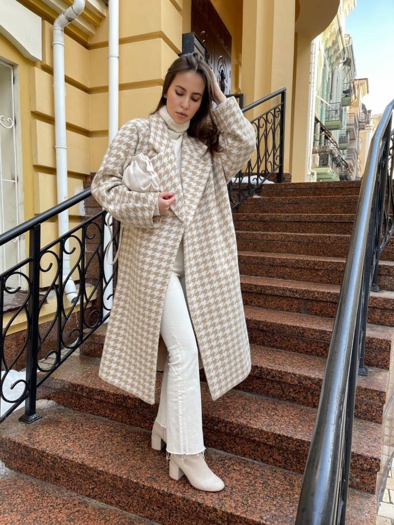 Ivory houndstooth coat with a white turtleneck, white jeans, cream boots and a cream pouch bag