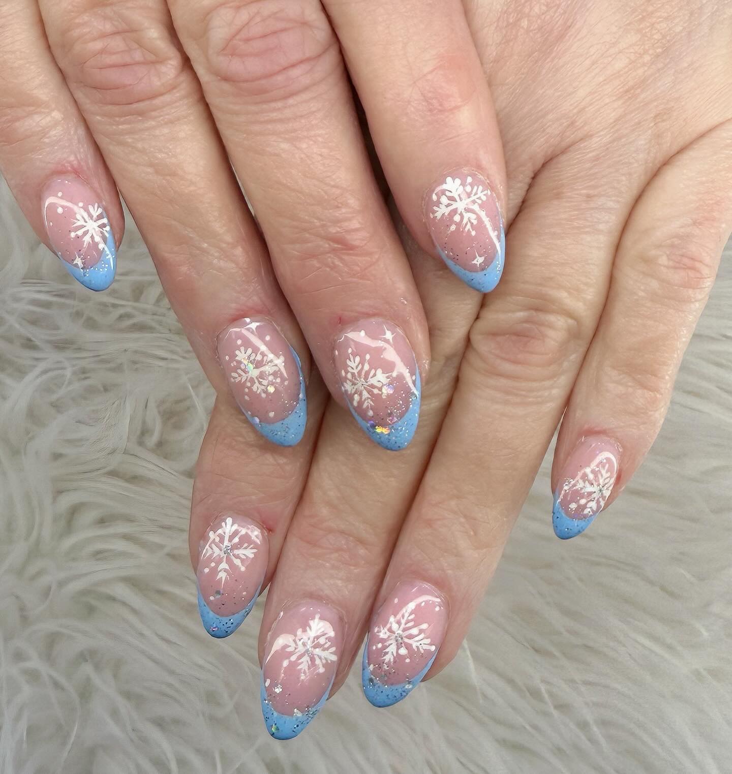 Pastel snowflake nails with glitter French tips