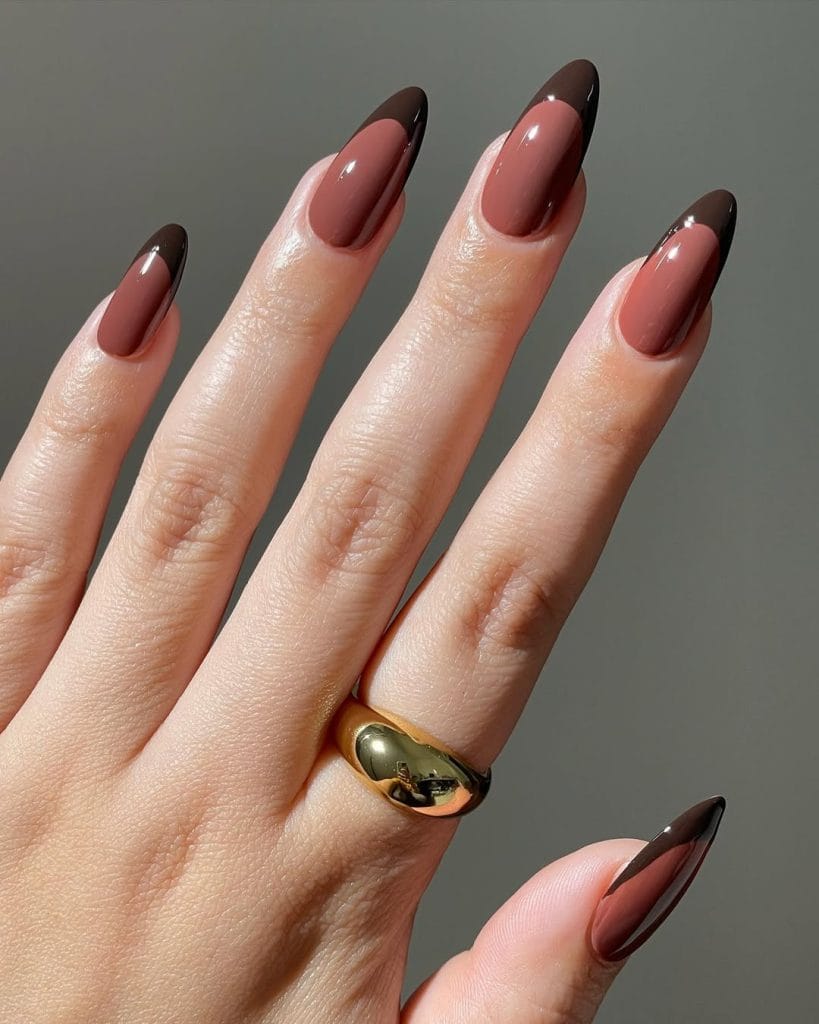 Short oval nails with chocolate brown French tips on nude base