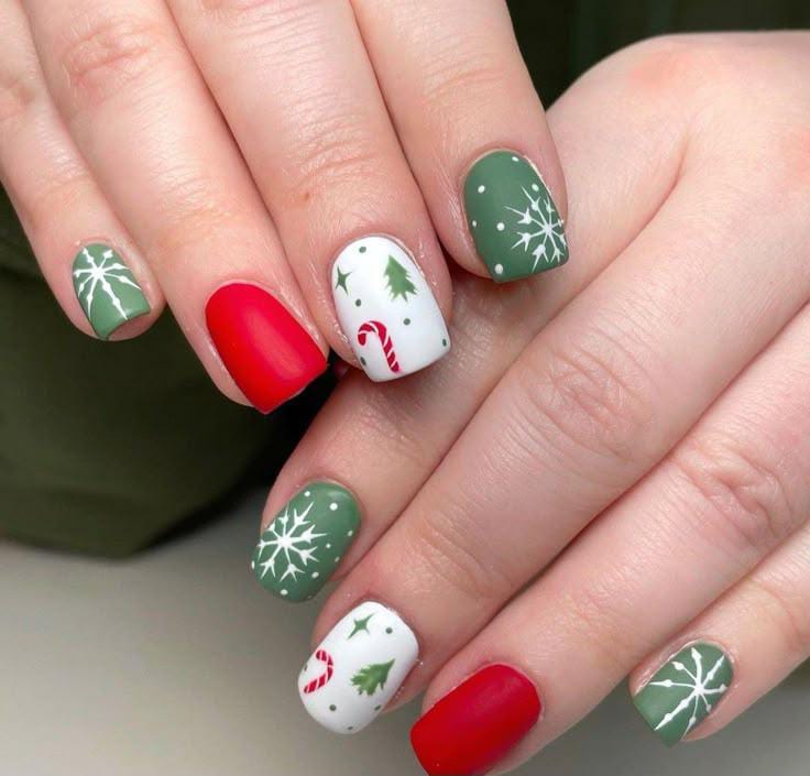 Matte sage green snowflake nails with red solids and white Christmas accent nails