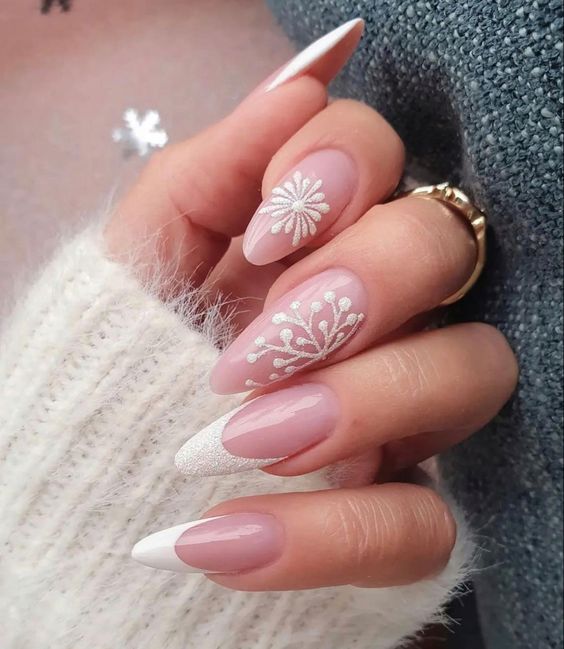 Long almond nails with white French tips and snowflake accents