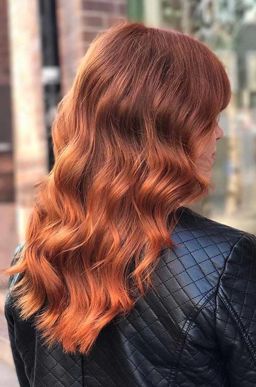 Three-quarter back view of long wavy copper hair melting from deep copper roots to bright penny-copper ends
