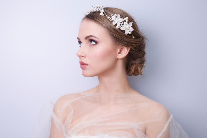 Bridal low chignon with a crystal floral headpiece and veil
