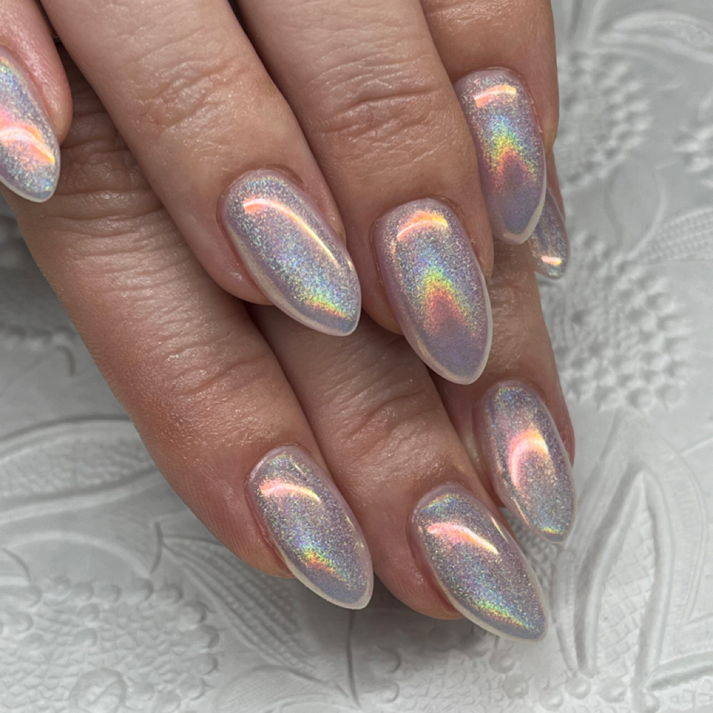 Salon manicure of nails with iridescent holographic chrome polish